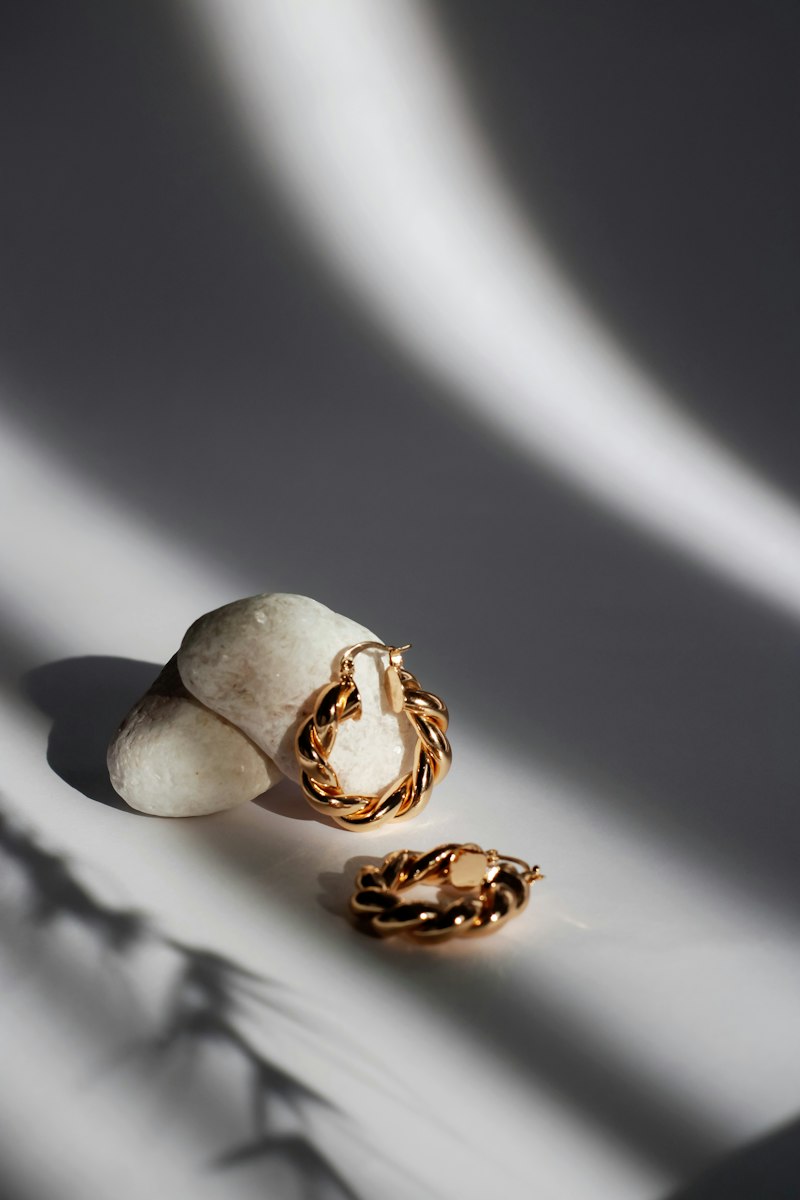 Argollas doradas de torzal con sombras dramáticas